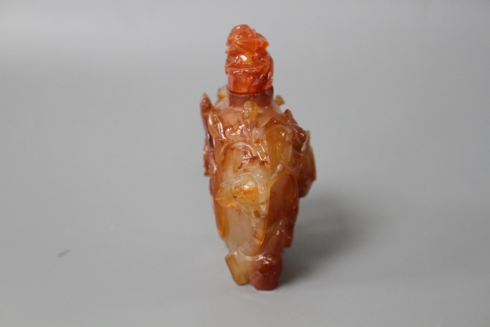 A Chinese orange agate snuff bottle and stopper, carved in relief with birds and flowers, width 6cm, height 8.5cm
